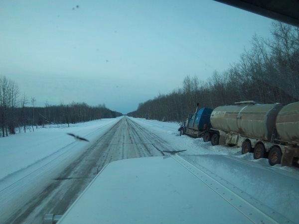 Crude Oil Hauling. Crude oil hauler stuck in the ditch.