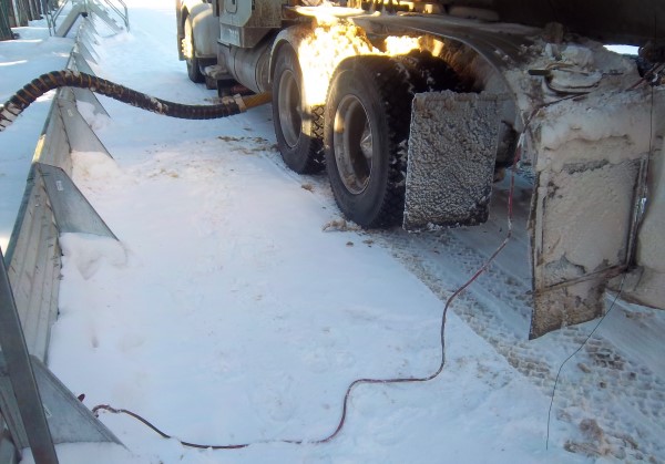 Crude Oil Hauling. Loading crude at the wellsite