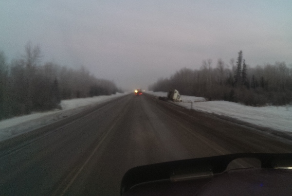 Oilfield Accidents. Bobtailing truck slides in the ditch on an icy road.