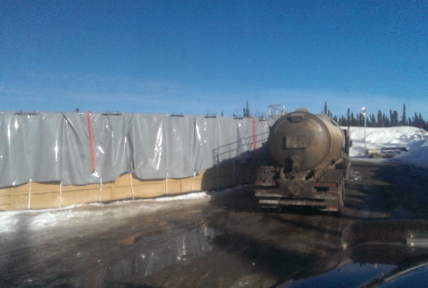 Frac Hauling. Filling a c-ring with water for a frac job