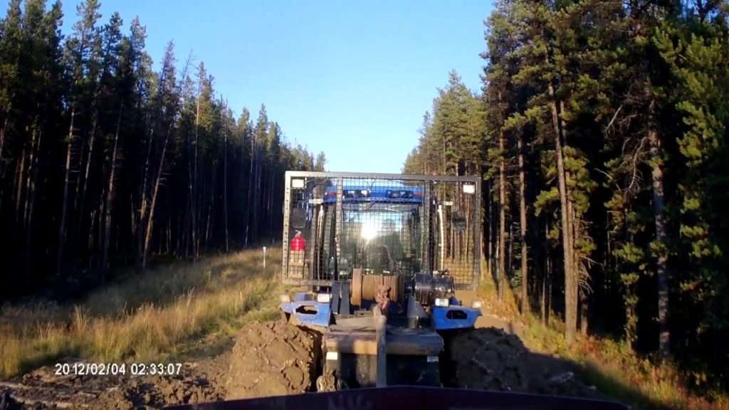 Oilfield Trucking videos. Getting towed up a muddy hill