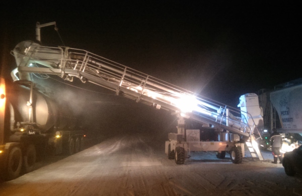 Frac hauling. loading frac sand from rail cars at night