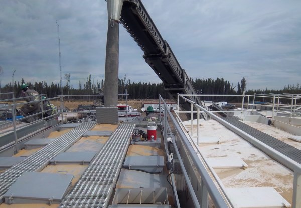 Telebelting Photos. Replacing the frac sand being pumped down the well