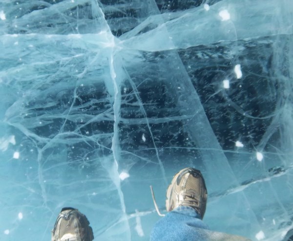 Ice Road Drivers. Checking thickness of the ice