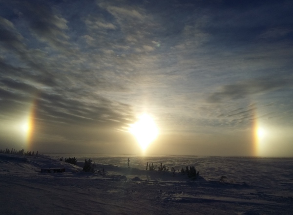 Sunrises, sunsets, sun dogs, Northern Lights and skies. Sun dog as seen from Lockhart Lake base camp on the ice roads.