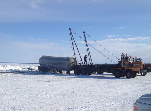Ice road accidents. Recovery on a tanker in the middle of great bear lake. Special equipment was used to lift the trailer out of the ice and pull it to safety.